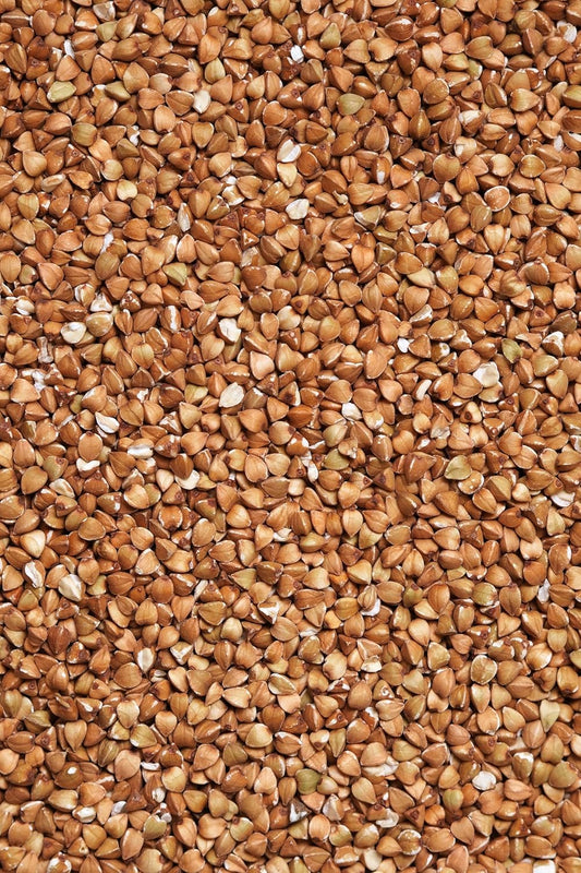 Close-up of certified organic hulled buckwheat groats – clean, golden-tan grains grown in Canada.